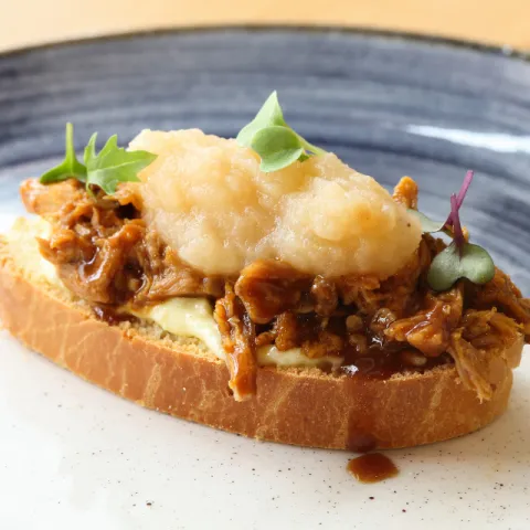 Montadito de cochinillo con manzana reineta, aire de ajo y su crujiente