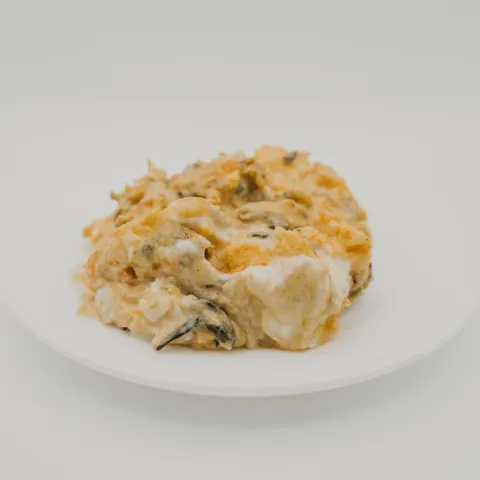 Zona A. Con alma viajera y sabor de los que permanecen en la memoria. El pollo se envuelve en una cremosa salsa de nata y pimentón, coronada junto al huevo cocido para crear un bocado lleno de tradición, personalidad y mucho compás.